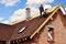 Roofers lay and install asphalt shingles. Roof repair with two roofers. Roofing construction with roof tiles, asphalt shingles.