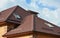 Roofing construction with attic skylights, rain gutter system, roof windows and roof protection from snow