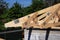 Roofing construction house corner roof with wooden beams, trusses, frame, timber and measurement tape. Roofing house construction