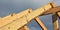 Roofing construction during the roof framing with a close-up of wooden roof truss, rafters and ridge beam