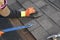 ROOFING WORK: professional roofer repairs shingles.
