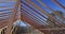 A roofing worker gives details about the wooden roof frame at the construction site of a new house