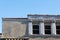 Roofline of a building with both plain stucco and ornamental window facing, terra cotta tile roo