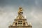 roofs of ancient buildings with gilded figures against a gray sky in antwerp on the central square