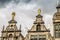 roofs of ancient buildings with gilded figures against a gray sky in antwerp on the central square