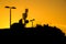 Roofs of buildings with many antennas in a big city at sunset