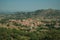 Roofs in hilly landscape covered by rocks and olive tree near Monsanto