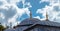 Roofs of a historic building in Turkey in front of a blue-white dramatic sky