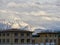 Roofs of hotels and snowy mountains on a cloudy day