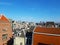 The roofs of houses in the center of Amsterdam under a clear sky