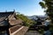 Roofs of one of the oldest historic Zen Buddhist Temple Complex Seifuku-ji in Nagasaki with Nagasaki landscape.