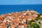 Roofs of town Piran with a bright blue sea in the background.