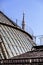 Roofs of the Vittorio Emanuele II Gallery. Highline Gallery and in the background the Madonnina spire of Duomo Cathedral in Milan