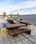 A rooftop deck and mountainous landscape background