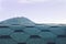 Rooftop of Green designer hexagonal asphalt, bitumen shingles on blurred background of a mounain peak and morning sky