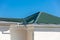 Rooftop of house with metal rain gutter system against blue sky