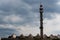 Rooftop of industrial halls and an inactive municipal heating plant chimney converted into a mast for telecommunications antennas