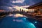 Rooftop infinity pool with panoramic city views at late sunset time