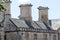 Rooftop stacks on medieval building. Close-up of historic roof detail