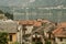 Rooftop view of an old city and lake at the background.