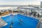 Rooftop view of swimmers at a luxurious hotel penthouse pool and bar overlooking Copacabana Beach in Rio de Janeiro, Brazil