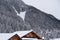 Rooftops filled with Snow after a Heavy Snowfall and the Snowy Italian Mountains with the Cableway on the background