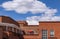 Rooftops of Santa Fe New Mexico Looking across the street from on rooftop to stucco buildings with balconies and a bright red um