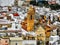 Rooftops in Spain, yellow church mosque surrounded by white buildings