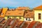 Rooftops with windows shaped like eyes and medieval style architecture in Sibiu Hermannstadt, Romania, on a hot, sunny day.