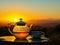 a Rooibos tea set against the backdrop of a South African sunset