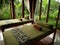 room with beds green blankets unity with nature large windows landscape fresh air