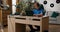 Room of a boy of elementary school age. A child enters the room sitting in a comfortable chair at a desk, a student in a