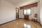 Room with a chair, wooden radiator cover, shiny oak parquet flooring