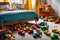 room cluttered with an array of colorful toys strewn about the floor, plush toys piled in a haphazard delight