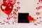 The room is decorated for Valentine's Day or Birthday. Red helium balloons, laptop, gift, decor, hearts