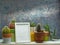 Room decoration with potted cactus, succulent plant and picture frame mockup on white shelf against old blue wall