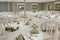 a room filled with tables and chairs covered in white linen