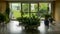 Room full of houseplants with a garden behind glass walls