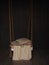 Room hanging swing with white blanket and pillows on a dark wooden wall background