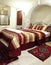 Room interior burgundy bedspread brass head board