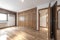 Room with large built-in oak wood wardrobe and oak parquet floors