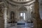 A room in one of the museums in Vatican City, Rome, with several marble statues of people and in the center a marble statue of a c