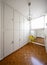 Room with white cabinets and a yellow stool