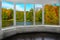 Room with window with view to autumn forest and lake. Autumnal landscape