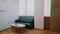 Room with wooden floor, black leather sofa and coffee table