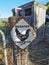 Rooster crossing rusty road sign