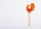 Rooster on a stick on a white background. Russian candies. Lollipop in the shape of a rooster.