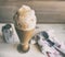 Root beer float in a tall pilsner glass, with ice cream scoop and soda can in the background.