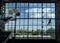 Rope access technician washes a hotel complex glass wall from in