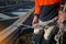 Rope access worker inspecting rope rigging on locking Karabiner its attached into 25 tone safety sling